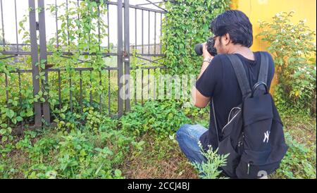 28th July 2020, Dhaka, Bangladesh . Boy Photographer . Boy Taking Photographs with her Canon Camera . Stock Photo