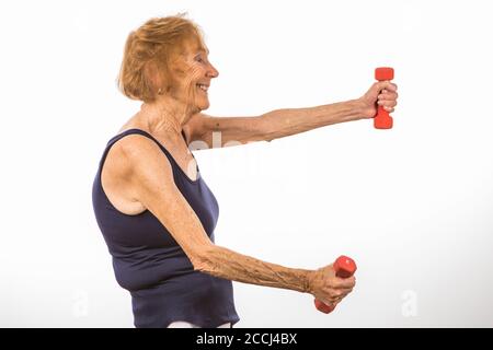 Senior Woman Enjoying Exercising By Lifting Two Pound Dumbbells Stock Photo