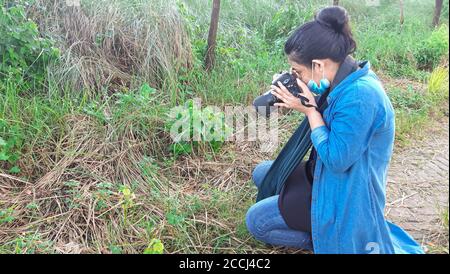 28th July 2020, Dhaka, Bangladesh . Girl Photographer . Girl Taking Photographs with her Canon Camera . Stock Photo