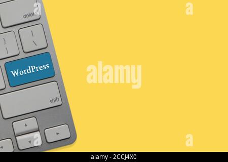WORDPRESS text on keyboard over yellow background. Business and technology concept Stock Photo