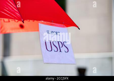 Lewisburg, United States. 22nd Aug, 2020. A sign reading 'support USPS' hangs from a protester's umbrella at a Save the Post Office rally in Lewisburg, Pennsylvania. The protests at local Post Offices across the United States were organized MoveOn, SEIU, NAACP, Indivisible and others to save the Post Office and to demand the resignation of Postmaster General Louis DeJoy. (Photo by Paul Weaver/Pacific Press) Credit: Pacific Press Media Production Corp./Alamy Live News Stock Photo