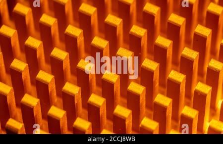 Background abstraction of an orange radiator for the processor in the form of columns lined up in a row. Technologies in macro photography Stock Photo