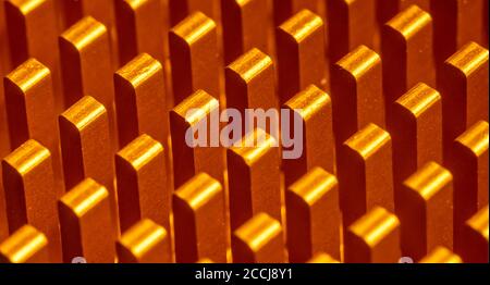 Background abstraction of an orange radiator for the processor in the form of columns lined up in a row. Technologies in macro photography Stock Photo