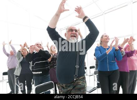 group of mature people applauding after meeting Stock Photo