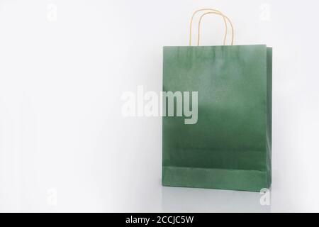 Plain green paper bag packaging on a white background with copy space Stock Photo