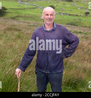 Healy Pass, Cork, Ireland. 22nd August, 2020. Farmer John O'Shea from Adrigole out walking his land on the Healy Pass in West Cork, Ireland. - Credit; David Creedon / Alamy Live News Stock Photo