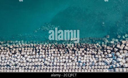 Aerial view of cement cube blocks protecting the shore from the waves in the port of Malaga, Spain. Stock Photo