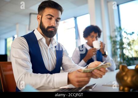 Accountant counting and checking money in the office Stock Photo