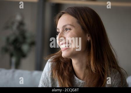 Happy young woman look in distance thinking dreaming Stock Photo