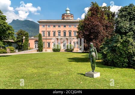 View of Villa Ciani with bronze statue foreground in the public city park of Lugano, Switzerland Stock Photo