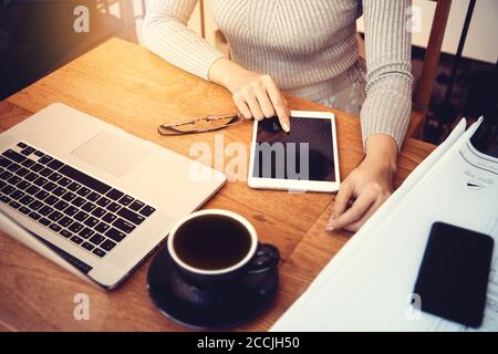Asian architect woman working at home with tablet and blueprints, engineer inspection in workplace for architectural plan,sketching a construction pro Stock Photo