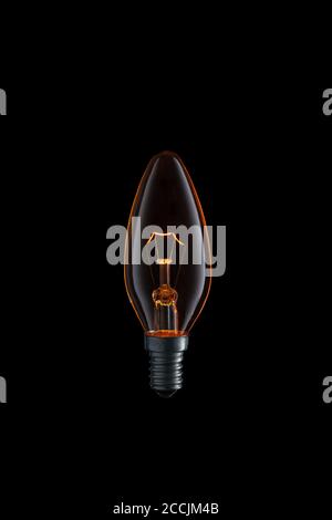 Burning Light bulb on black background. Stock Photo