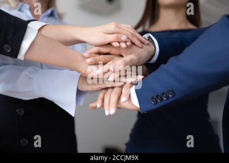 Group of diverse colleagues stacking hands together Stock Photo