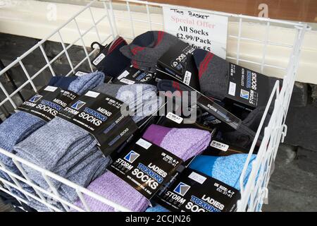 walking socks for sale outside a shop in coniston lake district, cumbria, england, uk Stock Photo