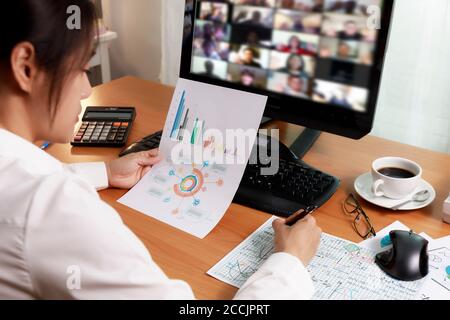 Asian business women working at home online meeting with video conference on computer. Business people using computer online meeting and speaking with Stock Photo
