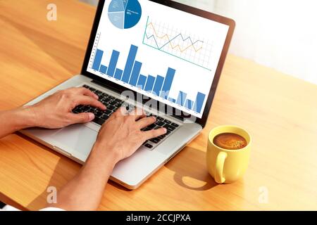 Businessman analyzing statistics on laptop screen, Hands man use laptop working with financial graphs charts online, Business and financial concept, W Stock Photo
