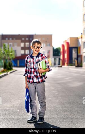 A small child with a school bag during the flash goes to school . First day of school Stock Photo