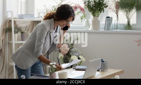 Smiling young businesswoman discussing color patterns with client. Stock Photo