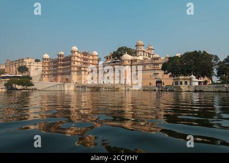 View of the City Palace from a boat cruise on lake Pichola. One of the most important landmarks of Udaipur and a major tourist attraction in Rajasthan Stock Photo