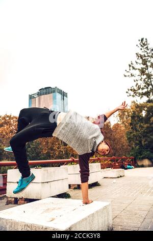 Young man jumping against clear sky Stock Photo