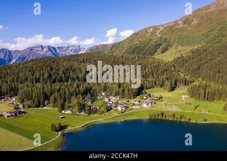 Switzerland, Canton of Grisons, Davos, Aerial view of villas on shore of Lake Davos in summer Stock Photo