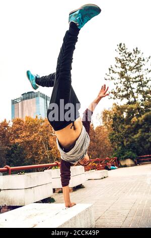 Young man doing handstand against clear sky Stock Photo