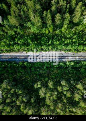 Russia, Petrozavodsk Oblast, Karelia, Railroad track crossing forest, aerial view Stock Photo