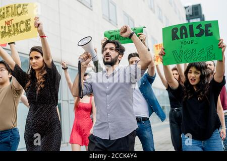 Multi ethnic activists protesting in city Stock Photo