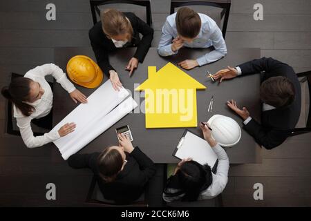 Top view of people around table in construction business meeting Stock Photo