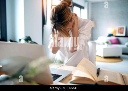 Tired woman working at home Stock Photo