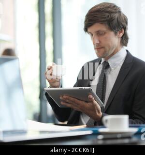 Business man with tablet computer in cafe Stock Photo