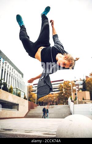 Young man jumping against clear sky Stock Photo