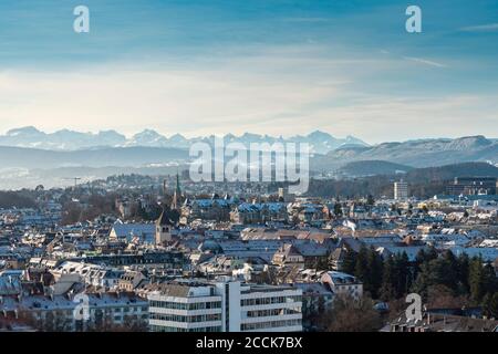 Switzerland, Zurich, City with snow covered mountains in background, aerial view Stock Photo