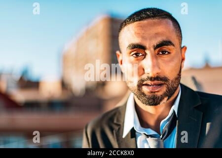 Young male professional in suit at rooftop Stock Photo