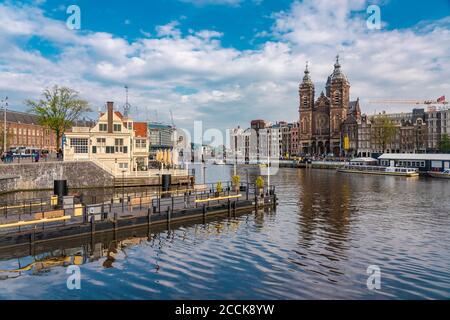 Netherlands, North Holland, Amsterdam, City canal with Basilica of Saint Nicholas in background Stock Photo