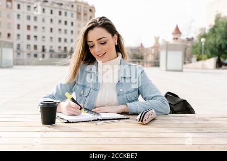 Female student studying at table in university campus Stock Photo