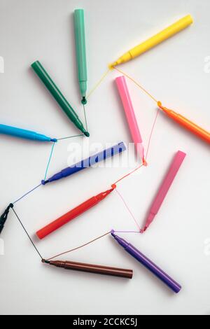 Colorful felt tip pens connected with lines Stock Photo