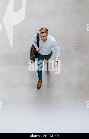 High angle view of entrepreneur with bag walking in city