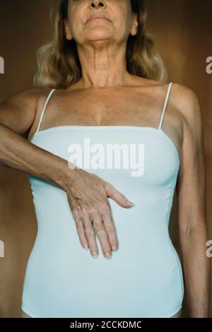 Senior woman touching her belly Stock Photo