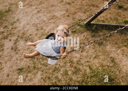 Cute little girl on  a swing Stock Photo