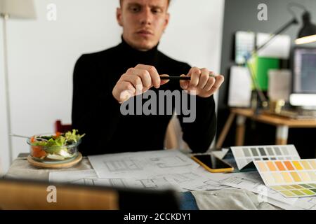 Thoughtful architect working at home office Stock Photo