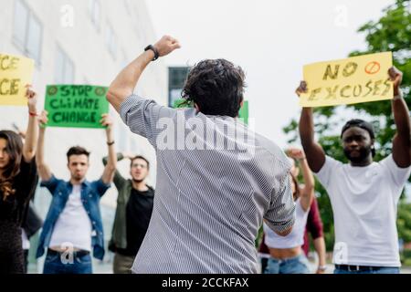 Protestors with banners protesting on street in city Stock Photo