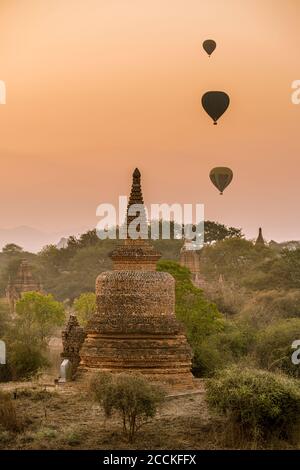 Myanmar, Mandalay Region, Bagan, Hot air balloons flying over ancient stupas at dawn Stock Photo