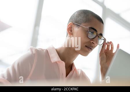 Portrait of businesswoman with glasses using laptop Stock Photo
