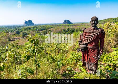 Myanmar, Mon state, outside of Mawlamyine, Buddhist monk statues in field at Win Sein Taw Ya Stock Photo