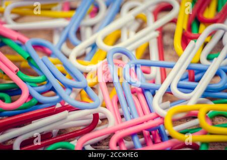 Macro photo of multicolored paper clips. Bright background made of colored paper clips, close-up Stock Photo