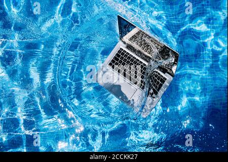 High angle view of computer floating on swimming pool Stock Photo