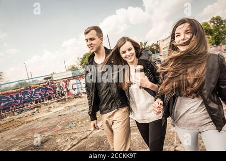 Group of friends hanging out in an old run down industrial area Stock Photo