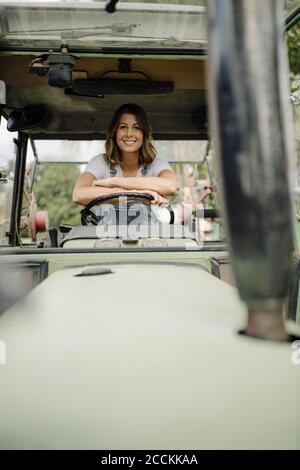 Portrait of confident young woman in a tractor Stock Photo