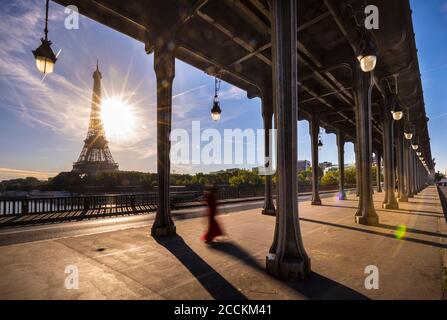 Eiffel Tower seen from bridge against blue sky during sunny day, Paris, France Stock Photo